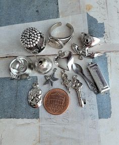 12 vintage silver-plate and silvertone charms including a locket ring and spinning carousel. Please expect minor aging/shelf-wear and overall glorious character. You'd receive all 12 pieces  Thank you for looking Locket Ring, Pendant Locket, Vintage Silverplate, Bling Bling, Carousel, Vintage Silver, Charm Pendant, Locket, Spinning