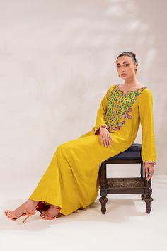 The embellished Kameez Trouser Raw Silk Pakistani Eid Dress is a perfectly stitched masterpiece adorned with glamorous details of crystals and beads. Shimmering sequins and embroidery work give a traditional touch to this premium Pakistani Dress, making it an epitome of beauty. Detailed Description: SKU: PS1826 Detailing: Embroidery, Threads, Pearls, Sequins, Beads Color: Yellow Fabric: Raw Silk, Organza Design: Fully Embroidered dress Event: Festive, Party wear Eid Dress, Dress Event, Eid Dresses, Embroidery Threads, Pakistani Dress, Silk Organza, Yellow Fabric, Embroidery Work, Raw Silk