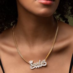 Our popular Double Plated Iced Princess Crown Name Necklace boasts a chic and elegant design, handcrafted to perfection. The model showcases the necklace with an 18-inch Cuban chain (see video for reference). You can personalize this item with Letters, Numbers, and Roman Numerals and choose from chain lengths of 14", 16", 18", and 20". Each chain features a lobster clasp closure for secure wear.Chain width:Cuban Chain - 3.7 mmFigaro Chain - 3 mmRope Chain - 2.3 mm XO Chain - 5 mm Personalized Gold Cuban Link Jewelry, Elegant Personalized Yellow Gold Chain Necklace, Classic Gold Diamond Name Necklace, Elegant Personalized Cuban Link Chain Necklace, Fine Jewelry Cuban Link Necklace, Fine Jewelry Cuban Link Necklace For Gift, White Gold Cuban Link Diamond Necklace Gift, White Gold Cuban Link Jewelry Gift, Elegant Personalized Link Necklaces