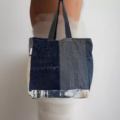 Denim handmade shoulder bag width 39cm length 40cm.  ✨Each bag is a one of a kind as it is made from responsibility sourced denim, and made by hand in our UK based studio. ✨The bags are a square shape and have a panel on the bottom which allows for plenty of storage space. There is also a pocket on each side panel. Our super cute "reworked by Ruthie" label is featured on the side of the bag. ✨The bags are made of a single layer of denim and are finished with an overlocked stitch on the inside of Everyday Rectangular Denim Bag, Rectangular Denim Canvas Bag With Pockets, Rectangular Denim Blue Cotton Shoulder Bag, Everyday Dark Wash Cotton Shoulder Bag, Denim Blue Cotton Tote Shoulder Bag, Rectangular Dark Wash Bag For Everyday Use, Recycled Denim Hobo Bag For Everyday Use, Everyday Recycled Denim Tote Bag, Everyday Recycled Denim Rectangular Bag