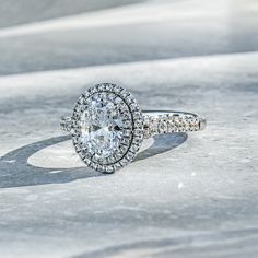 an oval diamond ring with two rows of diamonds around it