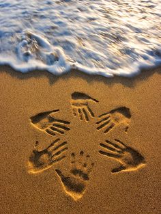 an image of a starfish drawn in the sand at the beach with waves crashing on it