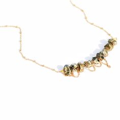 Delicate pyrite stones wrapped in gold chain. Necklace is 15" long. Can be lengthened upon request. 14k Gold-filled Wire Wrapped Necklace, Gold-plated Wire Wrapped Jewelry, Gold Wire-wrapped Metal Jewelry, Gold Plated Jewelry With Natural Stones, Dainty Yellow Gold Wire Wrapped Necklace, Bronze Brass Jewelry With Beaded Chain, Bronze Brass Beaded Chain Jewelry, Gold Brass Chain Necklace With Beaded Chain, Gold Brass Necklace With Natural Stones