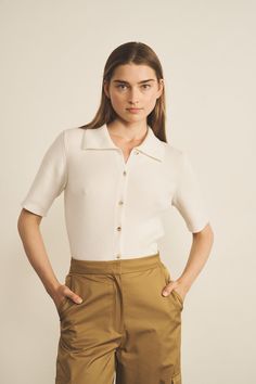 The Elise polo shirt is one of our spring - summer collection novelty.It will soon become an essential in your wardrobe. Unisex and elegant, worn next to the skin, you can easily slip it under jeans or even shorts during your summer days.Its cashmere ribbed edges add a touch of style to a casual look. Charlotte's fashion tip: this classic and elegant piece can be worn for many different occasions. For you gentlemen, don't hesitate to wear it with shorts or cotton trousers. Classic Spring Collared Top, Classic Collared Spring Top, Classic Collared Tops For Spring, Fitted Short Length Tops For Work, Fitted Short Tops For Work, Fitted Collared Top For Summer, Spring Fitted Button-up Polo Shirt, Fitted Polo Shirt With Button Closure For Spring, Spring Cotton Polo Shirt With Collared Neckline