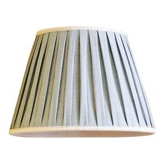 a pleated lamp shade is shown against a white background with light brown stripes on the bottom