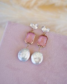 Add a touch of elegance and feminine flair to your wedding day look with our stunning Arabella Pink Drop Earrings. These beautiful gold and pink drop earrings feature eye-catching freshwater coin pearls, making them a perfect choice for the boho bride who wants a pop of color to her wedding look.Crafted with high-quality materials, these drop earrings are designed to last for years to come. The delicate design and modern glam appeal makes them perfect for brides who want to keep it simple yet el Pink Pearl Charm Jewelry For Wedding, Rose Gold Baroque Pearl Jewelry For Wedding, Rose Gold Baroque Pearl Wedding Jewelry, Feminine Round Pearl Drop Jewelry, Feminine Bridal Earrings With Pearl Drop, Elegant Blush Earrings, Glamorous Pearl Drop Jewelry As Gift, Pink Pearl Charm Drop Earrings, Glamorous Pearl Drop Jewelry For Gift