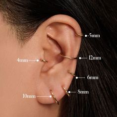 an ear with three different types of piercings on the top and bottom of it