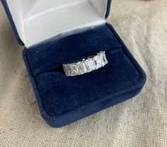 You will receive this pretty Cubic Zirconia Daisy eternity band.  it is a US size 4 1/2 and it has clear sparkly princess cut stones.  The ring is cast in sterling silver with a Rhodium plating and it is marked Ab S 925 inside.  This ring is in good pre owned condition with minimal signs of wear.  Box not included. For finished vintage assemblage and vintage inspired necklaces, bracelets, and earrings, please visit us at our other Etsy store, William Dalton Design: www.williamdaltondesign.etsy.com Vintage Assemblage, Stunning Necklace, Eternity Band, Eternity Bands, Princess Cut, Rhodium Plated, Assemblage, Necklaces Bracelets, Band Rings