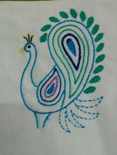 an embroidered peacock with green and blue feathers