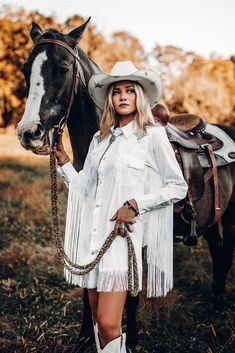 White and rhinestone bachelorette western shirt dress with fringe detail and long fun fringe in the back so you can really boot scoot. Made to order in size you need. Rhinestone bride on back and rhinestones on front of shoulders. Rhinestone Cowgirl Dress, Boujee Cowgirl, Western Fringe Wedding Dress, Vintage Cowgirl Outfits, Western White Dress Fringe, Rodeo Queen Costume, White Cowboy Boots Fringe, White V-neck Dress With Fringe, Western Bachelorette