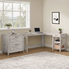 a corner desk with two drawers and a laptop on it in front of a window