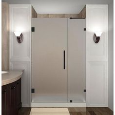 a bathroom with a walk in shower sitting next to a sink and mirror on the wall