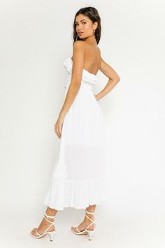 STYLE INFORMATION: The Delia White Strapless Midi Dress has us dreaming of sunny days! Lightweight, white woven fabric falls from a strapless neckline, into a ruffle smocked bodice (with tie-front), fitted waist and ruffle trimmed hem. DETAILS & CARE: Rayon. Hand wash cold. Imported. SHIPPING: We offer free shipping over $100 for all orders in the Continental US. Bandeau Beach Dress With Ruffles, Summer Strapless Ruched Tube Top, Strapless Ruffle Dress For Vacation, Strapless Ruffled Dress For Vacation, Strapless Dress With Ruffles For Vacation, Strapless Dress With Ruched Bodice For Brunch, Ruched Bandeau Strapless Dress For Day Out, Strapless Bandeau Dress With Smocked Back For Day Out, Summer Beach Tube Top With Ruffles