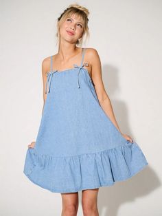 Chic Bow Denim Mini Dress: Your Summer Style Essential Cotton Mini Dress With Tie Back For Casual Wear, Summer Denim Blue Knee-length Dress, Denim Blue Cotton Summer Dresses, Denim Blue Knee-length Summer Denim Dress, Denim Blue Knee-length Summer Dress, Denim Blue Cotton Dresses For Summer, Trendy Summer Cotton Denim Dress, Trendy Cotton Denim Summer Dress, Summer Knee-length Denim Dress