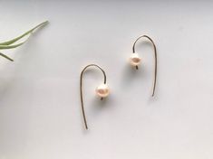 These delicate threader earrings are made of 14k gold filled wire and beautiful freshwater pearls. The pearls are held in place by the shape of the threader and hammered ends. The variation in the pearl enhances the organic and modern feel of these earrings. Length of the earring is approximately 1.25 inches Also available in sterling silver Modern Pearl Jewelry, Pearl Threader Earrings, Freshwater Pearl Earrings, Freshwater Pearls Earrings, Threader Earrings, Bridesmaid Earrings, Wedding Earrings, Pearl Jewelry, Favorite Jewelry