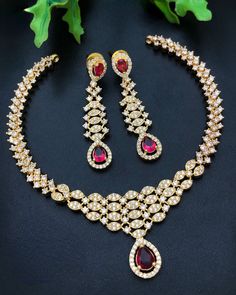 Add an elegant sparkle to your next special occasion in this CZ Diamond AD necklace set. The stunning American Diamond set is a gorgeous Indian jewelry set, featuring a bold Pink stone CZ necklace and earring set for a dazzling and trend-forward look. Perfect for Bollywood-inspired styling, these luxurious pieces will make a stunning accent to any outfit. Ad Necklace Set, Indian Jewelry Set, American Diamond Necklaces, Necklace Set Indian, Indian Jewelry Sets, Bollywood Jewelry, Party Necklace, Cz Necklace, Kundan Necklaces