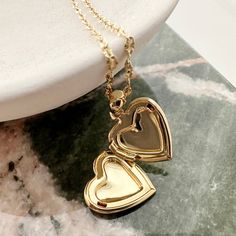 A romantic and timeless locket in a modern, dainty silhouette. The functional heart locket hangs upon a delicately twisted chain. Versatile enough to simply be worn solo or layered as the perfect compliment to your favorite necklaces. Adjustable between 18-21". Locket measures 1/2". Do you plan on adding a photo? Please see our handy locket template here. Our materials make for an amazing, high quality, seamless, jewelry piece with longevity. Our necklaces are plated with 18k gold, 18k rose gold Golden Heart Locket, Locket Gold, Twisted Chain, Bar Pendant Necklace, Heart Locket Necklace, Daisy Necklace, Rose Quartz Necklace, Initial Pendant Necklace, Locket Charms