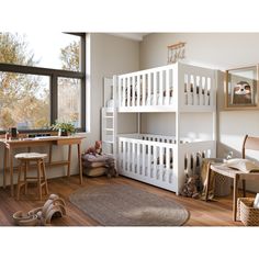 a white bunk bed sitting next to a window in a room with wooden floors and furniture