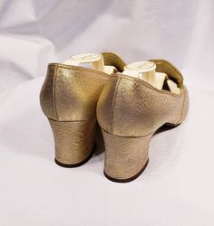 1960's gold lame' shoes with embroidered vamp and chunky heel Cute mid century modern pair of low heels. Size marked 7 B Measuresments: length ~ 9 1/2 inches, inside width ~ 2 3/4 inches, outside heel ~ 2 inches Sole reads: QualiCraft Worn 1x. These shoes are a ready to be worn! Buyer to pay all related shipping costs including insurance. Questions welcome. All Sales final Thank You CityVintage Retro Round Toe Heels For Wedding, Retro Almond Toe Heels For Party, Gold Heels With Round Toe, Vintage Round Toe Heels For Party, Vintage Heels With Round Toe For Parties, Vintage Party Heels With Round Toe, Retro Almond Toe Wedding Heels, Gold Block Heel Wedding Shoes For Evening, Gold Low-heel Wedding Shoes For Evening