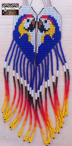 the beaded necklace is made with different colors and shapes, including blue, yellow, red