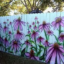 a white picket fence with purple flowers painted on it