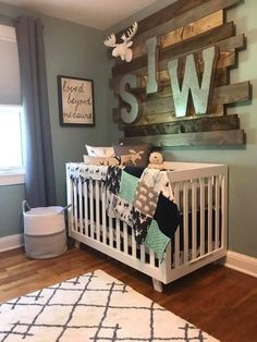 a baby's room with a white crib and wooden letters on the wall