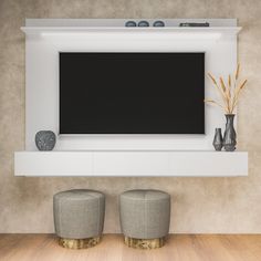 two stools in front of a flat screen tv mounted on a wall above it