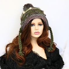 Comfortable and fun to wear, this soft funky snow hat has braids for ties. The top has a matching pom pom and the body has textural bumps worked in, giving a rustic edge to your look. You can roll back the brim to give a different look, or leave a bit of a brim. I've shaped it to sit secure on your head and cover your ears so you can wear it untied, but the braids are still long enough to tie if you want to. Great for skiing, sledding, going to an outdoor market, running your errands, or just sh Adjustable Cap For Cold Weather, Quirky Winter Hat, One Size Fits Most, Quirky Winter Hats, One Size Fits Most, Fun Brimmed Winter Hat, Whimsical Winter Hats Adjustable Fit, Fun Winter Brimmed Hats, Whimsical Winter Hats With Adjustable Fit, Whimsical Adjustable Winter Hat, Quirky Winter Hats One Size Fits Most