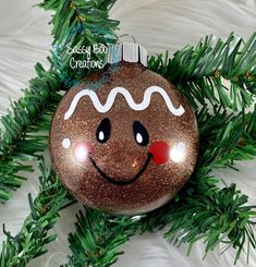 a christmas ornament with a smiling face on it