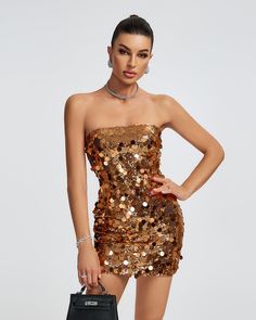 Get ready to shine and turn heads in our Open Back Sequins Embellished Mini Dress! This stunning dress features a strapless design and is adorned with sparkling sequins throughout. Perfect for a night out or special event, this dress will make you stand out and feel confident. Our Style No.ZNSBA780 Bead Piece Height - 68.9"/175cm Bust - 34.6"/88cm Waist - 25.6"/65cm Hips - 36.6"/93cm and wears size S About Wholesale/Dropshipping, please contact us! Note: Colour may vary due to lighting on images Gold Sequined Mini Dress For Evening Wear, Gold Mini Dress With Contrast Sequin For Party, Gold Party Mini Dress With Contrast Sequin, Date Night Embellished Mini Sequin Fabric, Glamorous Embellished Sequin Club Dress, Glamorous Embellished Sequin Dress For Club, Sequin Dress For Club Evening, Embellished Sequin Mini Dress For Party, Embellished Mini-length Sequin Dress For Party