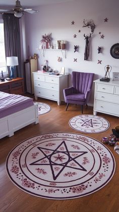 a bedroom decorated in purple and white with stars on the wall, rugs and furniture