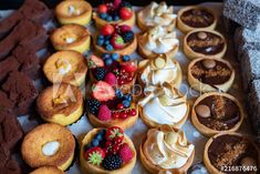 assorted pastries and desserts on display for sale