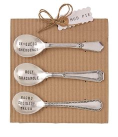 three silver spoons sitting on top of a napkin