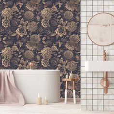 a bathroom with floral wallpaper and a bathtub in front of a mirror on the wall