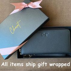 a black wallet with a pink bow on it and the words, all items ship gift wrapped