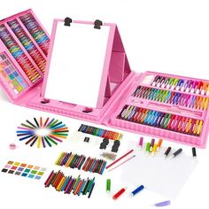 a pink case filled with lots of different colored crayons and markers next to a white board