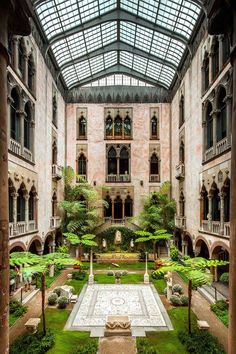 the inside of a building with many windows and plants