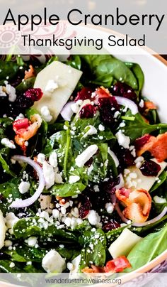 an apple cranberry thanksgiving salad with spinach and feta cheese in a bowl