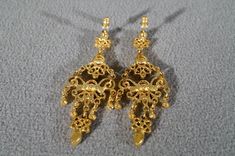 I am offering this fabulous vintage yellow gold tone pierced earrings. This piece is truly gorgeous, and it has the following features: * beautiful vintage earrings * yellow gold tone * chandelier style * faux amethyst * stud style * 2.5 inches in length This is a fantastic and classic piece. There is tons of sparkle and shine with this piece. It will beautifully complement your upcoming fashion season. Buyer pays all shipping and handling. Ornate Gold Plug Earrings For Wedding, Vintage Formal Filigree Chandelier Earrings, Victorian Gold Plug Earrings, Formal Vintage Chandelier Earrings, Victorian Chandelier Earrings For Formal Occasions, Victorian Chandelier Drop Earrings For Evening, Ornate Dangle Chandelier Earrings For Anniversary, Ornate Chandelier Dangle Earrings For Anniversary, Victorian Chandelier Earrings For Evening