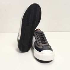 This leather lace up sneaker has been handcrafted from flawless grain leather, embellished with a leather insole that nods to the brand's heritage. Perfectly paired with tailored suits and leather jackets. Leather Lining for a luxurious feel and moisture control Leather collar and tongue Rubber sole Tapered round toe. The handmade sustainable Gommus rubber outsole and insole are Made in Italy. STYLE #D2168T Classic Navy Sneakers With Contrast Sole, Navy Leather Lace-up Sneakers, Sporty Navy Custom Sneakers With Rubber Sole, Navy Custom Sneakers With Rubber Sole, Navy Leather High-top Sneakers With Branded Insole, Classic Navy Sneakers With Round Toe, Navy Leather Sneakers For Streetwear, Navy Custom Sneakers With Contrast Sole, Navy Sneakers With Rubber Sole And Round Toe