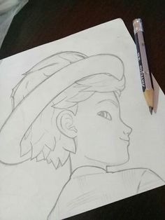 a drawing of a boy with a hat on his head and a pencil next to it