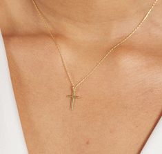 The 14K Solid Gold Small Cross Necklace is a symbol of faith, devotion, and timeless elegance. Crafted with meticulous attention to detail, this delicate piece features a tiny cross pendant made from 14K solid gold. Its simple yet profound design makes it a perfect religious necklace for women, suitable for various occasions such as baptisms, weddings, or as a thoughtful Mother's Day or birthday gift. As a symbol of one's faith and commitment, this cross necklace holds deep significance. It serves as a reminder of one's beliefs and values, offering strength, comfort, and inspiration to the wearer. Whether worn as a daily expression of spirituality or on special occasions to mark significant milestones, this necklace carries with it the blessings and well-wishes of the giver. For a bride, t Yellow Gold Cross Necklaces For Baptism, 14k Gold Cross Necklaces For Baptism, 14k Gold Cross Necklace For Baptism, Classic Cross Jewelry For Baptism, Classic Gold Jewelry For Baptism, Classic Crucifix Jewelry For First Communion, Classic Cross Pendant Jewelry For First Communion, Classic Cross Necklace For Baptism, Classic 14k Gold Jewelry For First Communion