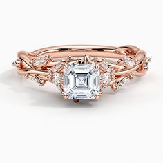 a rose gold engagement ring set with an emerald center stone surrounded by white diamond accents