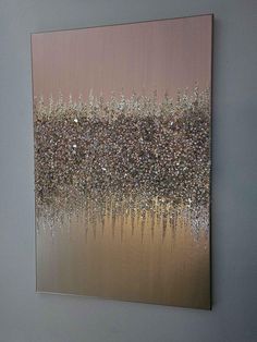 an abstract painting on the wall with silver and gold colors, in a living room