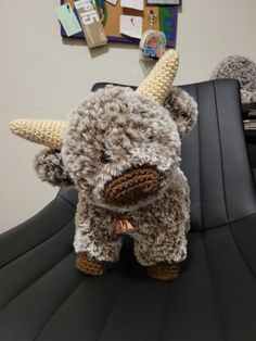 a stuffed cow sitting on top of an office chair