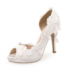 a white high heeled shoe with lace detailing