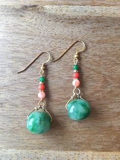 A pair of dangling earrings with two oval shaped green jade beads, decorated with genuine coral beads and green agate beads. - made with green jade rings, genuine coral beads and gold-plated 925 sterling silver beads, wire and hooks - approximately 57 mm / 2.24 inches length - approximately 15 mm / 0.59 inches in width and 13 mm / 0.51 inches in length of the oval shaped green jade Visit my shop for more: http://www.etsy.com/ca/shop/RitaCollection If you have any questions regarding the item or Handmade Jade Drop Earrings, Green Oval Jade Beads Jewelry, Green Oval Polished Beads Jewelry, Green Agate Teardrop Jewelry, Elegant Agate Gemstone Bead Earrings, Green Jade Earrings With Natural Stones, Bohemian Jade Gemstone Earrings, Bohemian Round Jade Earrings, Elegant Green Agate Earrings