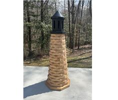 a wooden tower made out of bricks in the middle of a park with trees behind it