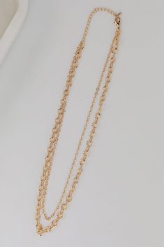 Adding the Sadie Gold Layered Chain Necklace to your daily necklace stack is guaranteed to up the cool-factor of any look! This trendy necklace features two layers of gold chains. Style the Sadie Necklace with any outfit to instantly upgrade your look! Gold Plated Layered Lobster Clasp with Extender Layer 1 | Length 8" Layer 2 | Length 7.5" Extender | Length 3" Trendy Multi-strand Layered Chain Necklace, Dainty Double Chain Link Necklace, Dainty Gold Multi-strand Layered Necklace, Dainty Multi-strand Gold Chain Necklace, Gold Multi-strand Clavicle Chain Necklace, Chic Layered Multi-strand Necklace With Double Chain, Chic Multi-strand Layered Necklace With Double Chain, Double Strand Metal Necklace With Delicate Chain, Trendy Chain Link Layered Necklace