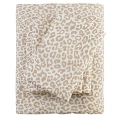 an animal print sheet set on top of a bed